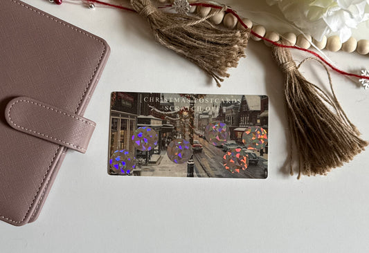 Christmas postcard scratch-off savings challenge a wallet on a light surface