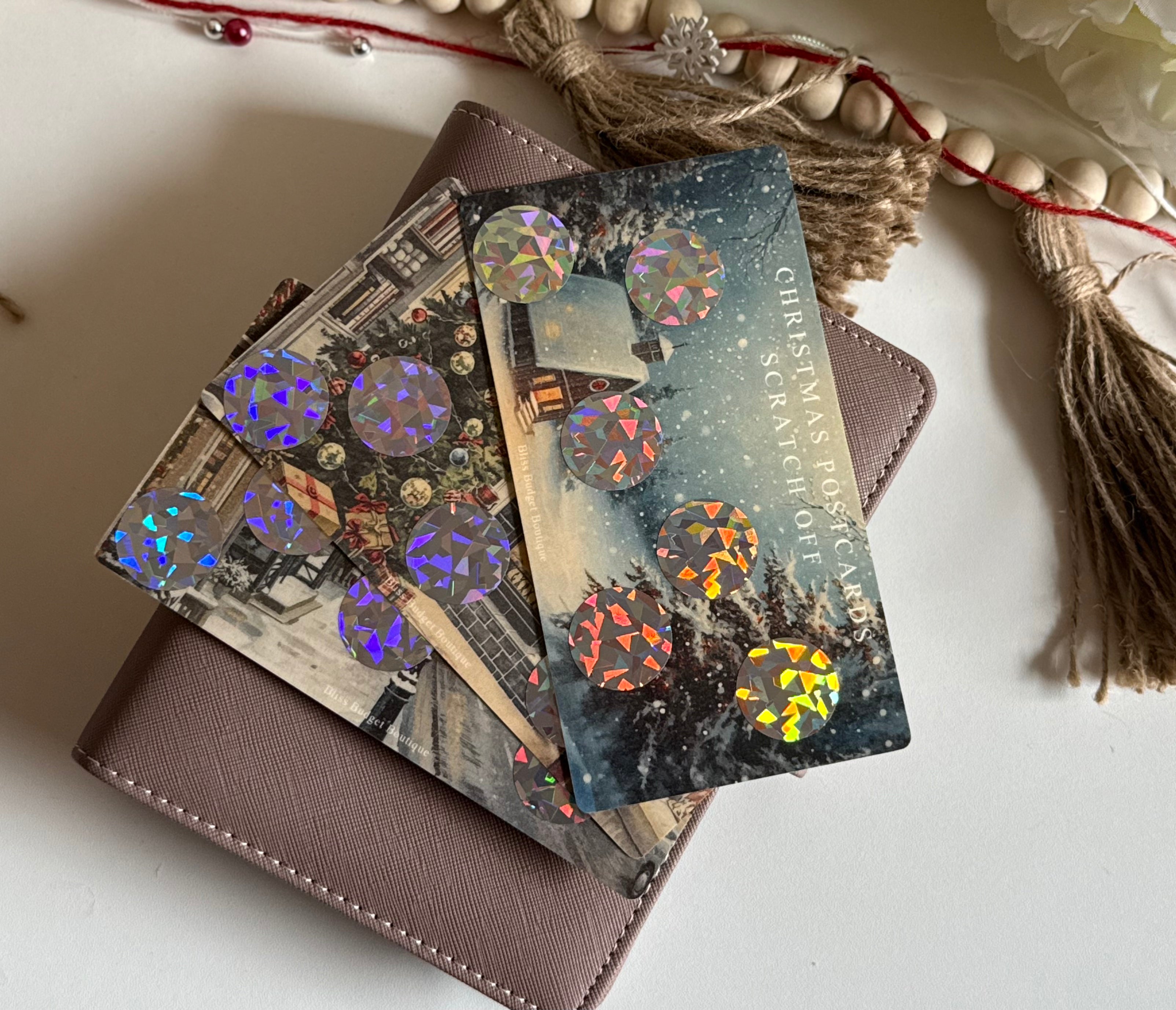 Stack of Christmas postcards with decorative elements on a white surface scratch off savings challenge